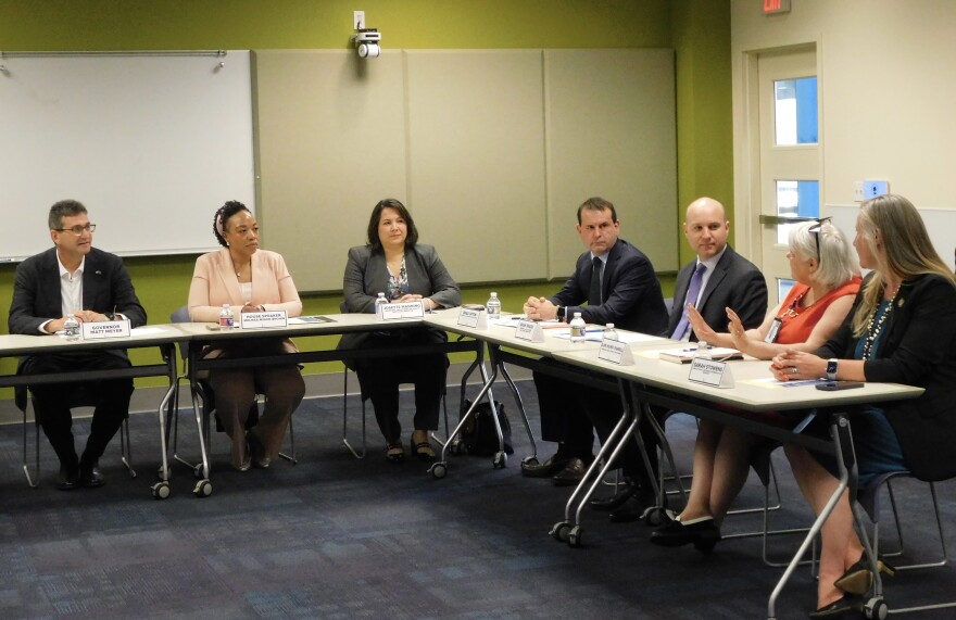 Gov. Matt Meyer (left) hosts a medical debt roundtable on Friday at the Bear Public Library in Bear, Del.