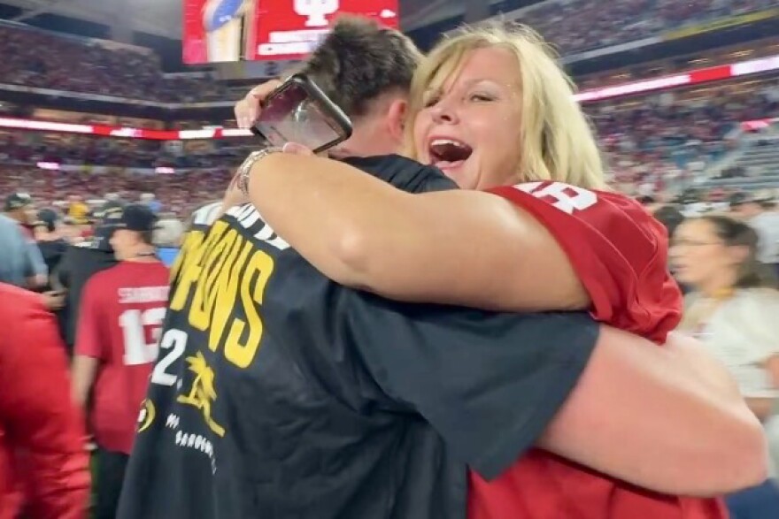 Post game hugs on the field after IU wins its first ever college football national championship.