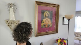 "Inez" looks at artwork her great grandmother brough to the family