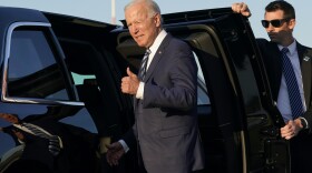 President Biden steps into a motorcade vehicle after arriving Wednesday at Royal Air Force Mildenhall in Suffolk, England, on the first leg of his European trip. "We have to end COVID-19, not just at home, which we're doing, but everywhere," he said.