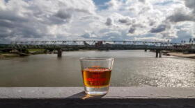 A glass of bourbon sits on the edge of the Purple People Bridge in Newport 