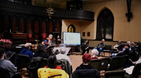 Evelyn Avoglia plays a backpacker acoustic guitar while teaching the audience several protest songs at a “teach in” at the Unitarian Universalist Congregation in Stamford to practice performing protest songs as part of a weekly Moral Mondays protests against federal deportation efforts on 2/11/26.
