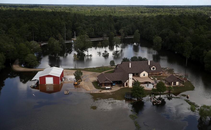 A Beaumont, Texas home surrounded by floodwaters in 2017. Places with less population density or less wealth are often less likely to receive federal flood mitigation funds.