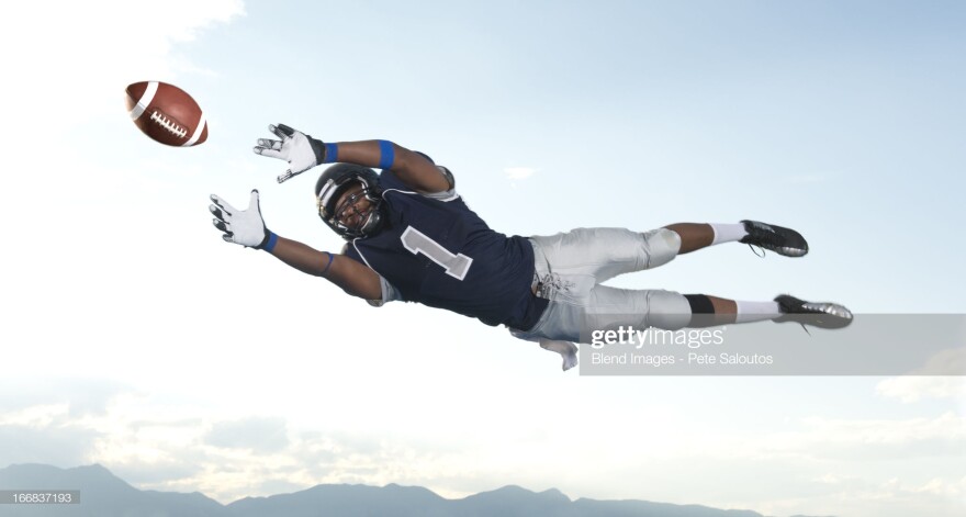 American football player catching ball