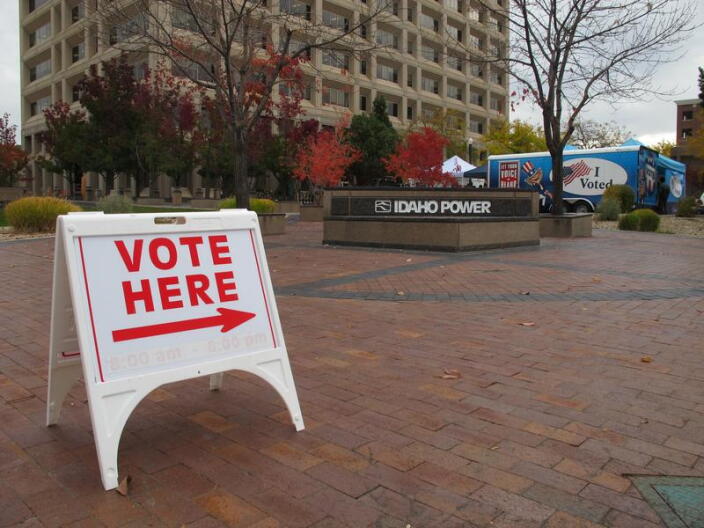 A white vote here sign in front of the Idaho Power sign. 
