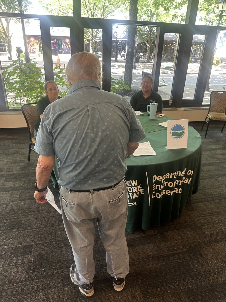 Homeowner speaks with DEC officials at public information session
