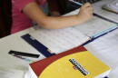 A homeschool math textbook rests on the table where Mabry Grant, 8, works on a lesson with her mom, Donya Grant, at their home in Monroe, Washington. (Ted S. Warren/AP)