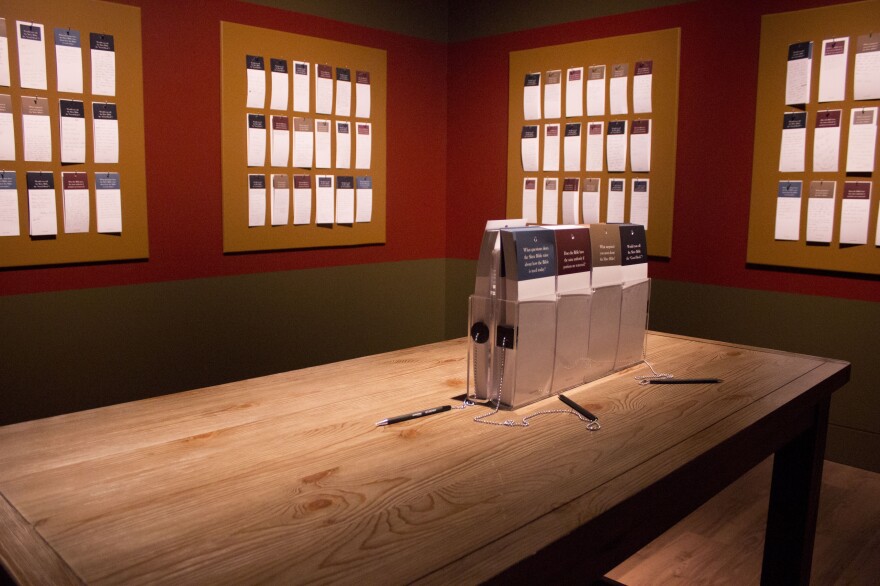 Visitors are encouraged to write down and share their reactions, with prompts such as "What questions does the Slave Bible raise about how the Bible is used today?"