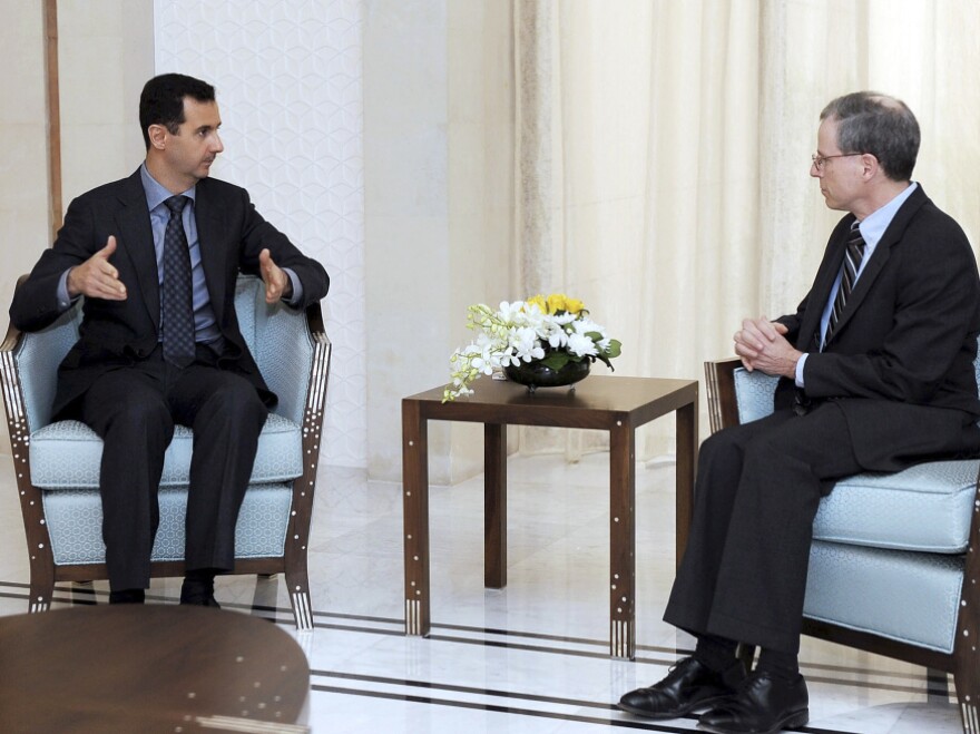 Syrian President Bashar Assad, shown meeting with U.S. Ambassador Robert Ford last January, blames the uprising in Syria on Islamic radicals.