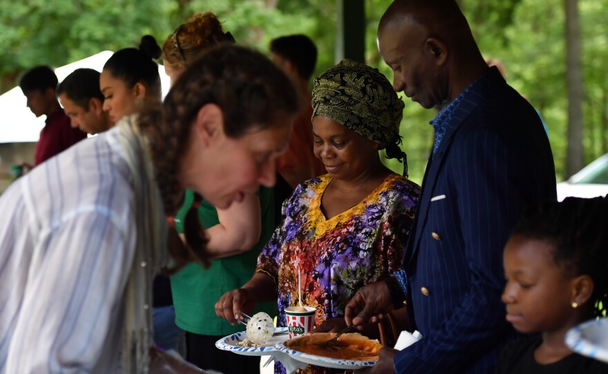 Nalusumu Bile and Mwefu Mwefu of Tanzania try different ethnic foods.