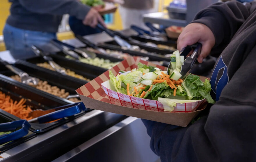 Students get lunch at the Tres Volcanes Community Collaborative School in Albuquerque on Tuesday.