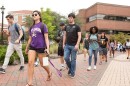 Students walk in front of a campus building at East Carolina University.