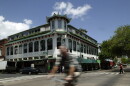 In this May 17, 2007, file photo, a bicyclist rides past the Wo Fat building in Honolulu's Chinatown.
