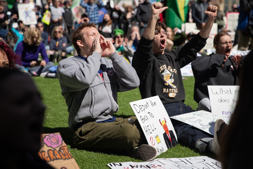 Demonstrators cheer for a speaker during the No Kings protest in Chester I. Lewis park on Saturday, March 28, 2026.