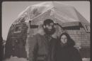 Alex and Meg standing in front of the new geodesic dome house they were building in Kotzebue in December 1975.