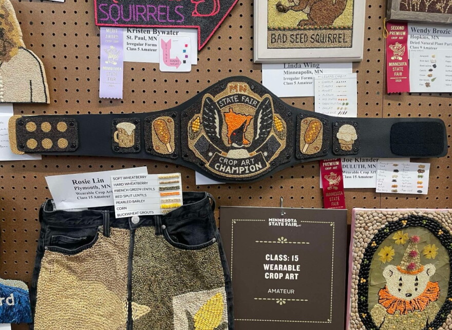 A wall of seed art with ribbons