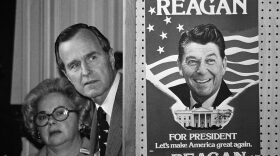 George H.W. Bush peeks at a poster of Ronald Reagan, then one of his opponents for the Republican party presidential nomination in 1980.  (AP file photo)