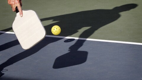 In this Monday, Dec. 3, 2012 photo, Del Teter competes in a game of pickleball at Sun City West senior community in Surprise, Ariz. A hybrid of tennis, badminton and table tennis, pickleball is played on a court a quarter the size of a tennis court, with hard rackets and a variety of whiffle ball. Created on the whim of a U.S. Congressman, pickleball has become a big hit in senior communities around the country, and is gaining steam with younger players and at schools, too. (AP Photo/Matt York)