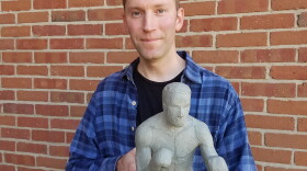 Sculptor John Hebenstreit holds the clay model he'll use to create an eight-foot bronze statue of Ezzard Charles.