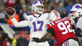 Buffalo Bills quarterback Josh Allen (17) throws under pressure from New England Patriots defensive tackle Davon Godchaux (92) during the first half of an NFL football game, Thursday, Dec. 1, 2022, in Foxborough, Mass. (AP Photo/Steven Senne)