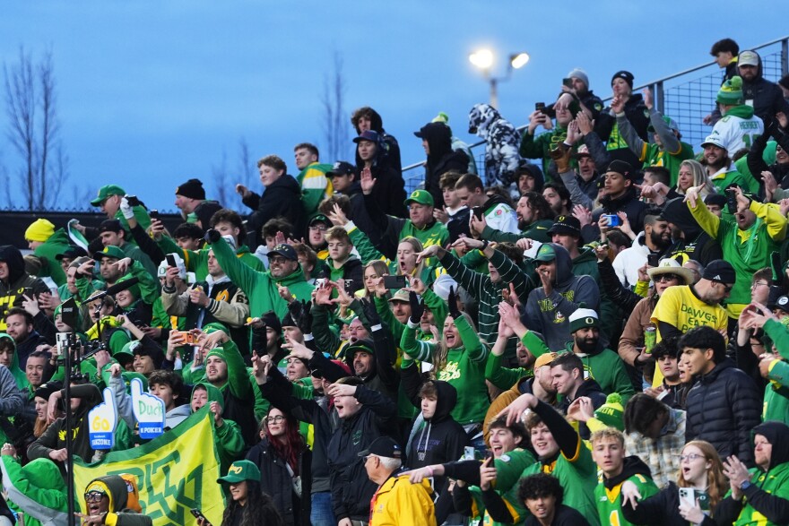 Oregon fans celebrate a win over Washington in an NCAA college football game, Saturday, Nov. 29, 2025, in Seattle.