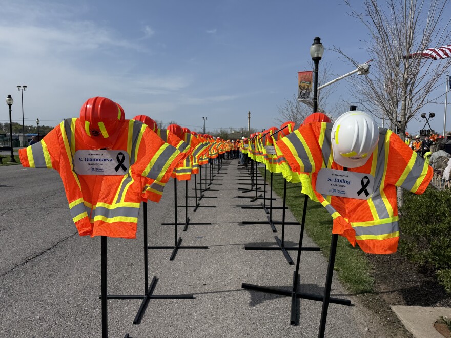 A display of vests and hard hats at the New York State Fairgrounds represents the road construction workers killed on New York roads