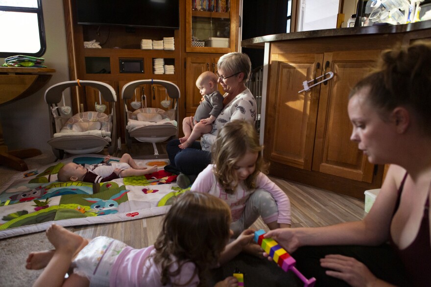 Chelsea watches Harper and Riley while Kim plays with August and Bishop, in their RV. Noah and Chelsea don't know how it will feel to be back in their house, one of the first on their street to be rebuilt.