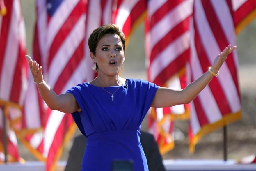 Arizona Republican gubernatorial candidate Kari Lake arrives to a rally with former President Donald Trump on Oct. 9, 2022, in Mesa, Ariz.