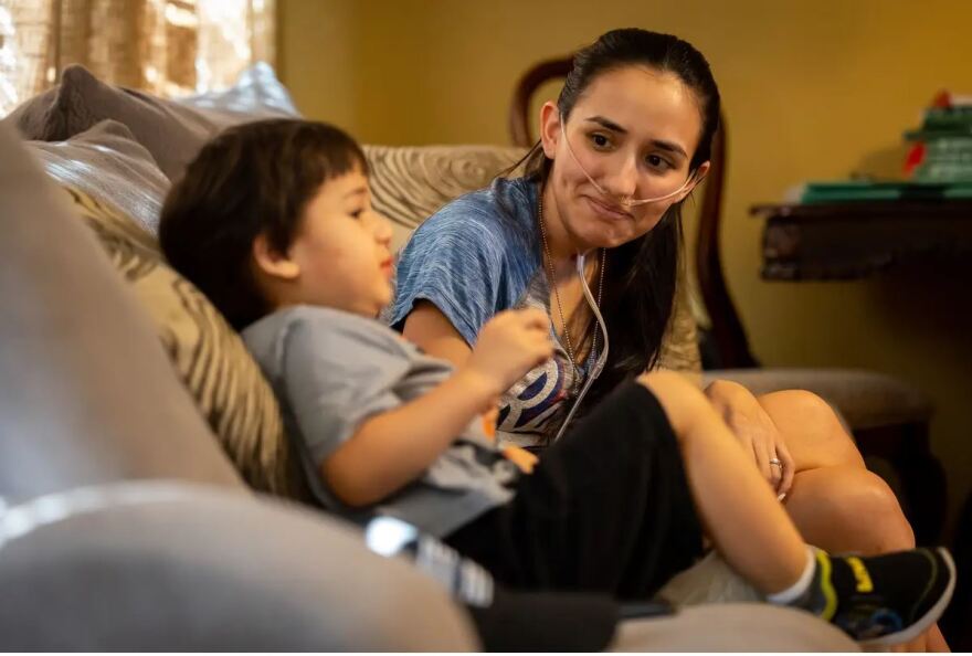 Diana Crouch smiles at her son, Cain, in their home.