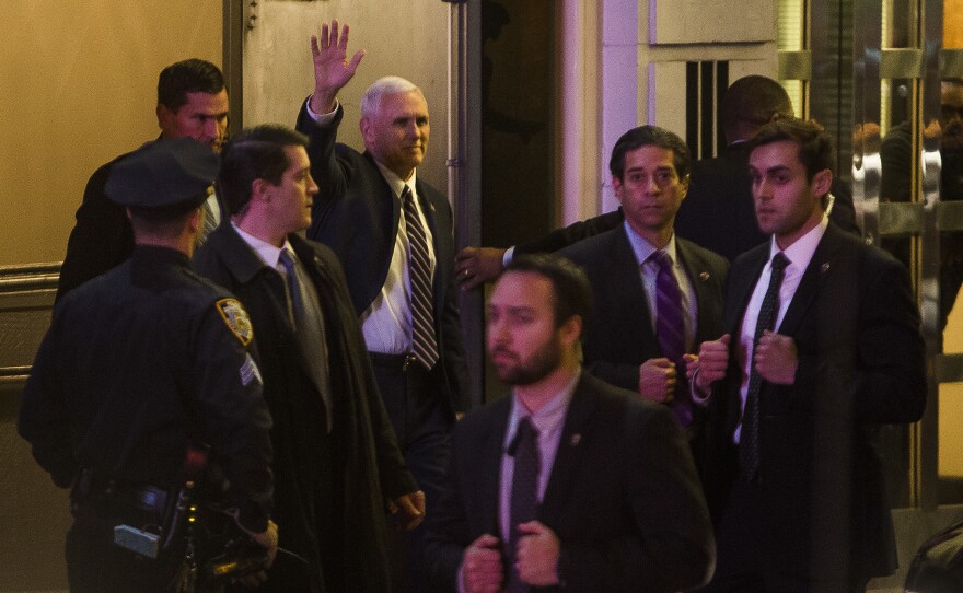 Vice President-elect Mike Pence, top center, leaves the Richard Rodgers Theatre after a performance of "Hamilton" on Friday.