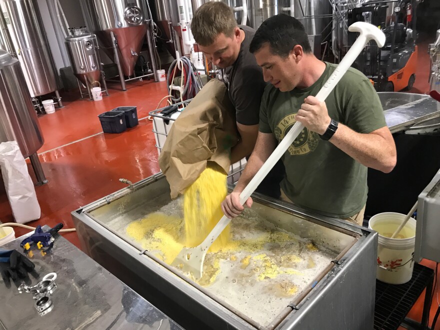 Zac Fike (L) and Matt Kehaya (R) work on a batch of beer at 14th Star Brewing Company. 14th Star donates some of its proceeds to local nonprofits.