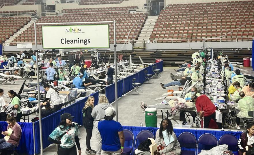 From above, a shot of the pop-up's cleanings station inside of the Coliseum Arizona State Fairgrounds. Temporary dividers separate stations.