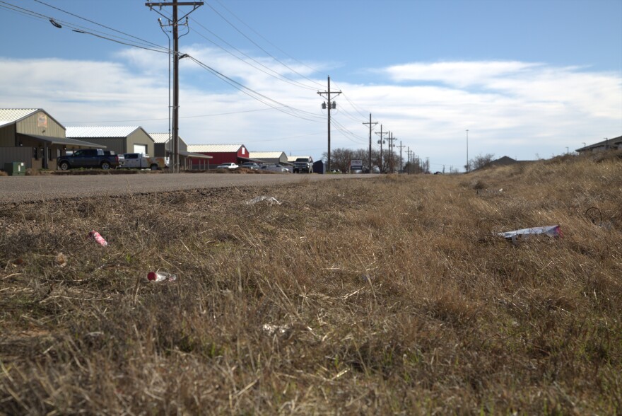 Loose trash on the side of Alcove Avenue, outside of an apartment complex south of the possible site for Lubbock's proposed waste transfer station.