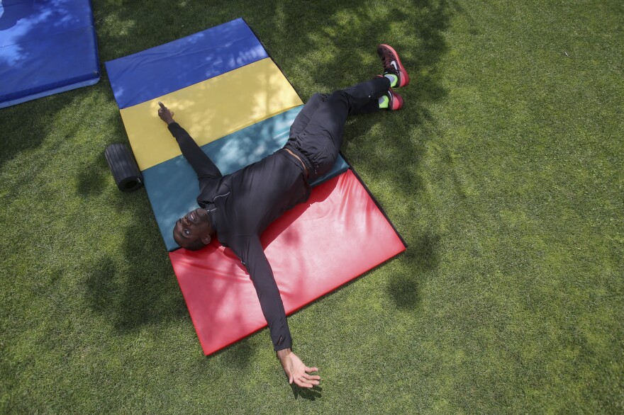 Gillette stretches during practice. "I was kind of enclosed by people's expectations," Gillette says. "But when I'm on the track and I'm running down the runway by myself and jumping into the air, it's like someone opens up this cage door and I'm able to go out and be free and do my own thing."