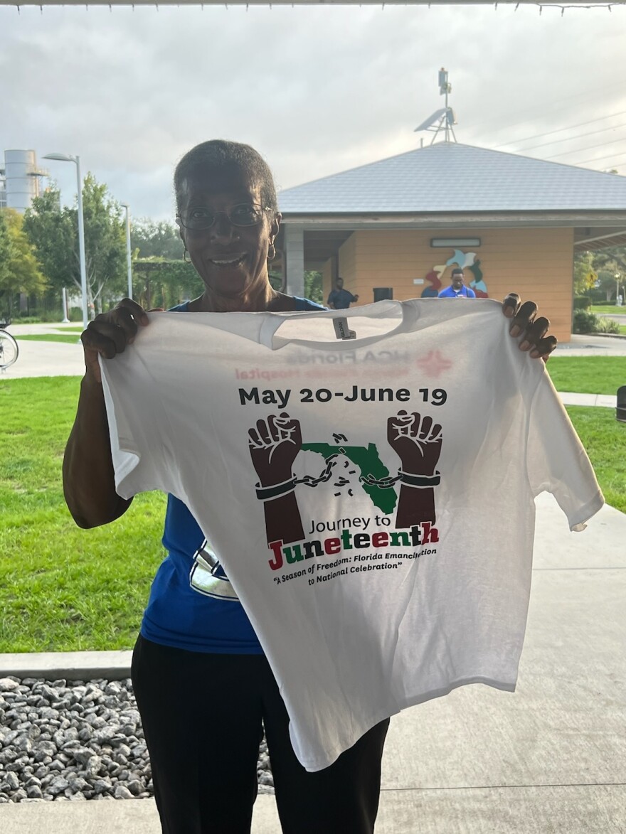 City of Gainesville employee Tara Carter shows off the official Journey to Juneteenth Freedom Walk Tee. [Photo by N’Jhari Jackson]