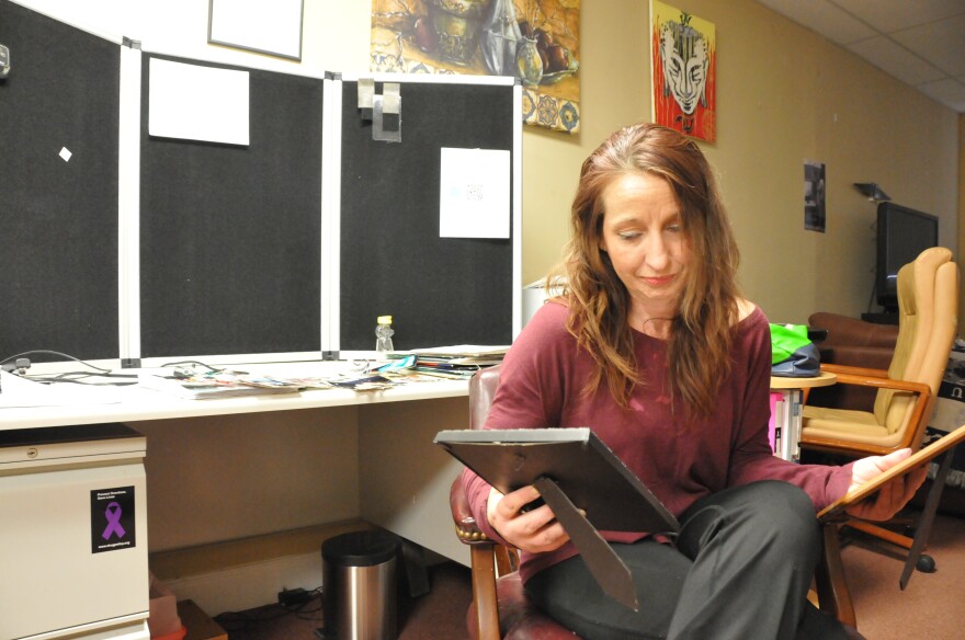 Louise Vincent sits in her office and looks at photos of Selena