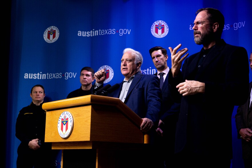 A man stands in front of a podium with a City of Austin logo on it.