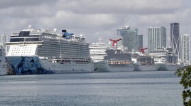 Cruise ships are docked at PortMiami on Tuesday. The U.S. Coast Guard has been working with cruise companies to bring people off of ships stricken with the coronavirus — but a new bulletin also says foreign-flagged ships should not rely on U.S. help.