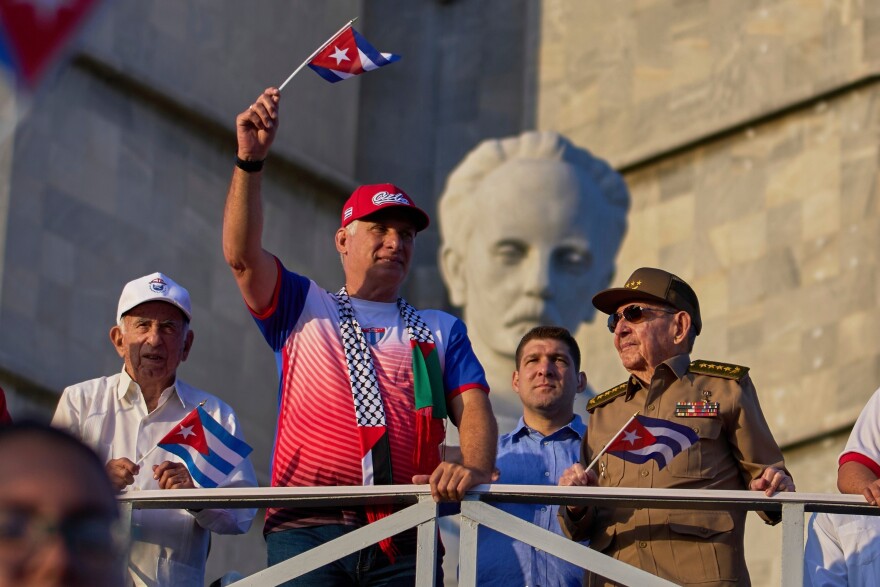 FILE - Raul Castro, right, watches the May Day parade accompanied by Cuba's President Miguel Diaz-Canel, second left, and Castro's grandson, Raul Guillermo Rodriguez Castro, center, at Revolution Square in Havana, May 1, 2025. (AP Photo/Ramon Espinosa, File)
