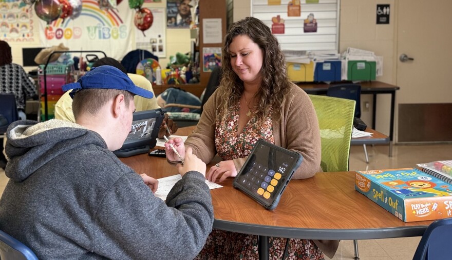 Monica Benson, the 2024-2025 Alachua County teacher of the year, is seen here working with two of her students. (Sydnie Espro/WUFT News)