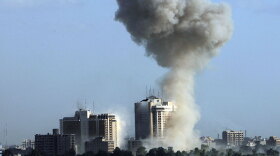 Smoke rises into the sky following one of three explosions Monday near Baghdad hotels.