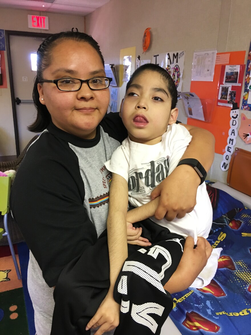 Felencia Woodie holds her son Dameon David, 8. He is one of seven medically fragile children who attend Saint Michael's Association for Special Education.