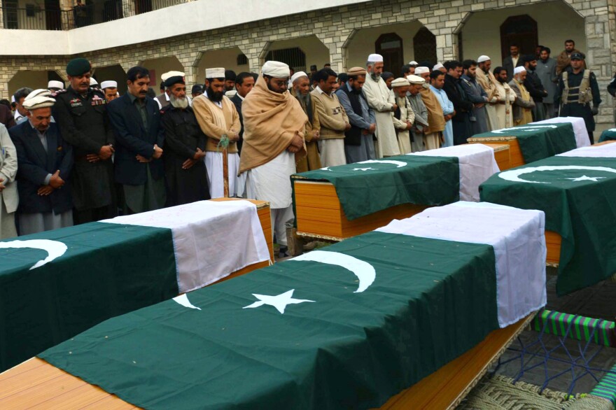 Security officials attend the funeral of police officials killed by bombs in Jamrud, Pakistan, March 1. The men were escorting a team of polio vaccinators when their vehicles were targeted.