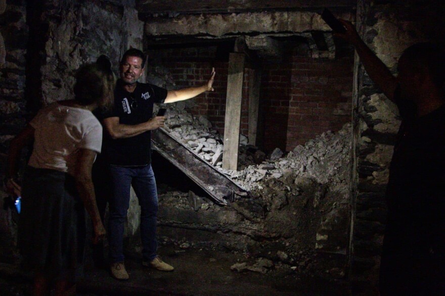 Eric Blumenthal, developer and owner of the Divine Lorraine Hotel building, shows Here & Now's Robin Young the basement level which includes an old entrance to a Prohibition era speakeasy. (Dean Russell/Here & Now)