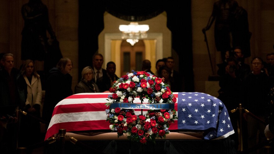 Former President George H.W. Bush's remains lie in state in the U.S. Capitol Rotunda on Monday.
