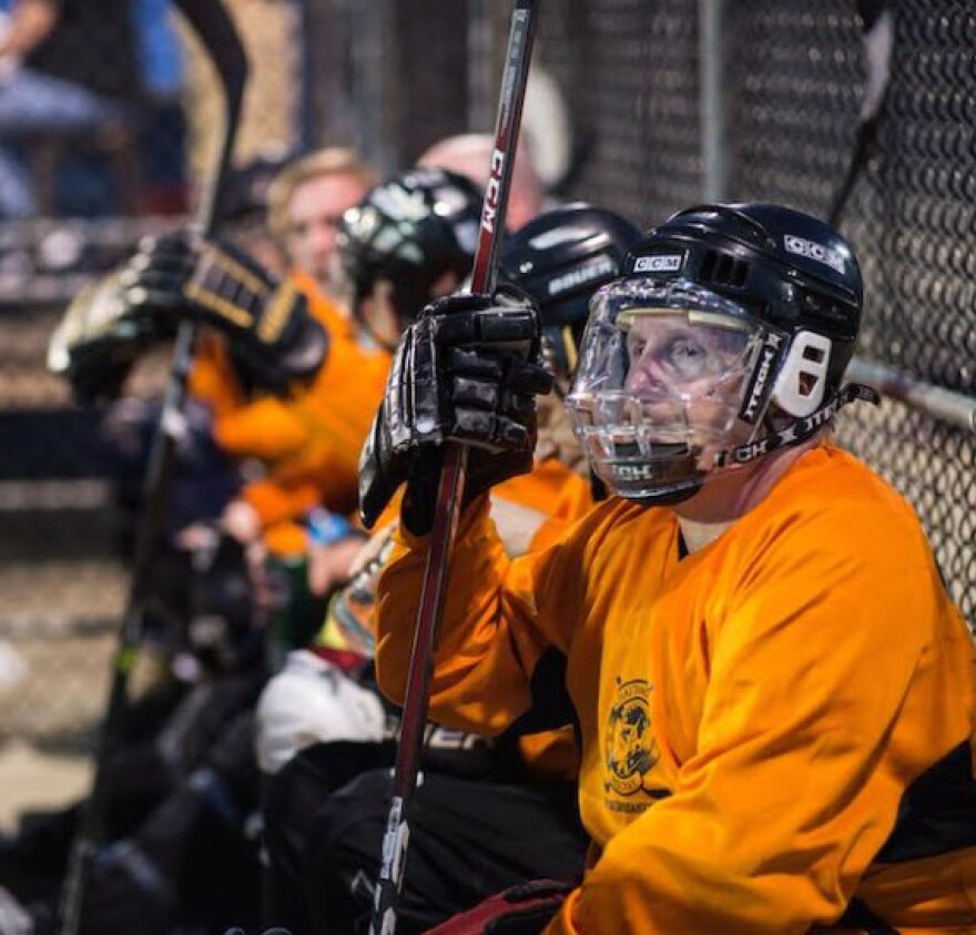 Inline hockey players on bench