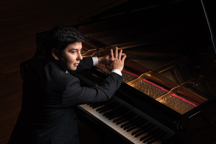 Behzod Abduraimov sitting at the piano