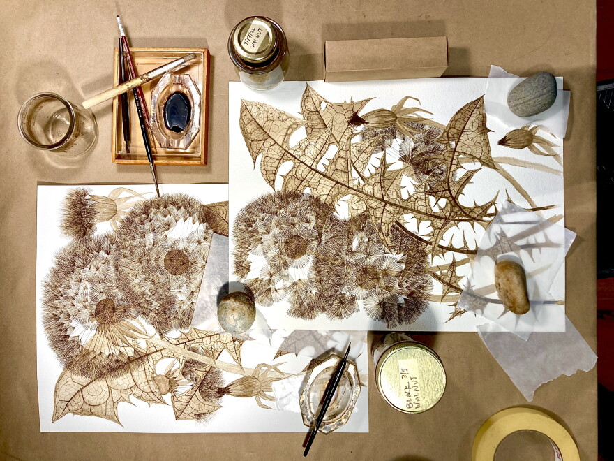 A desktop covered with artist materials.