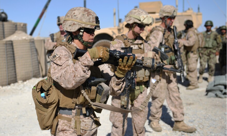 Female Marines unload their rifles after a patrol with Afghan soldiers in Helmand province in June. The Marine Corps leadership has started an experiment to determine whether female Marine lieutenants have what it takes to become infantry officers and lead on the battlefield.