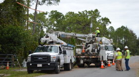Workers fix a power line outside a Palatka home following Hurricane Matthew in 2016. The Florida Public Service Commission on Tuesday approved a $318.5 million request by Florida Power & Light, the state's largest power company, to cover storm-related damage from the hurricane and to replenish the company's storm reserve fund. (File/WUFT News)